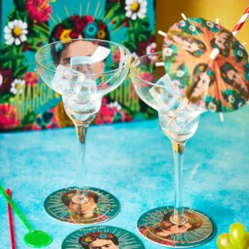 Mix up some of your favourite drinks and reference one of the world’s greatest female artists whilst you do it. The Frida Kahlo Margarita Cocktail Set comes with everything you need to get an arty party started - excepting of course the drinks themselves! With colourful Frida inspired Mexican style drink umbrellas for each glass and perfectly shaped cocktail glasses the Frida Kahlo Margarita Cocktail Set is a real statement of intent - an artist’s manifesto even - to get tipsy in style! The Frida Kahlo Margarita Cocktail Set also comes with a set of two coasters inspired by Frida’s style. Frida Margarita classic recipe Ingredients: Lime wedge, coarse salt, 60ml fresh lime juice (about 1 large lime), 60ml cup tequila, 60mm cup orange liqueur, coarsely cracked ice cube. How to make: Rub the rims of 2 martini glasses with a lime wedge, then dip the rims in a dish of course salt. Refrigerate the glasses if desired. In a shaker, combine the lime juice, tequila, and orange liqueur. Add ice and shake 10 to 15 seconds, then strain into the prepared glasses.